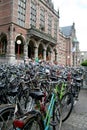 Many bicycles are parked in front od the historic University building in the Centre