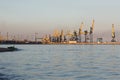 Many big cranes silhouette in the sea port of Azov at golden light of sunset. Mariupol Royalty Free Stock Photo