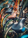 Many bikes in a row on the street. Bicycle parking. Colored bicycles on the street