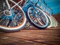 Many bikes in a row on the street. Bicycle parking. Colored bicycles on the street