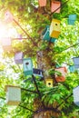 Many Birdhouses of different colors on the tree