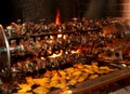 Many birds and roasts on a spit in the fireplace with a lot of p