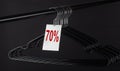 Many black hangers and text 70 percent sale on a rod .Black friday Royalty Free Stock Photo