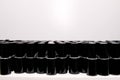 black jars of varnishes stand in order in rows