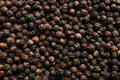 Many black peppercorns as background top view Royalty Free Stock Photo