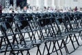 Many black plastic chairs in many rows. Preparation for the concert