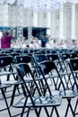 Many black plastic chairs in many rows. Preparation for the concert