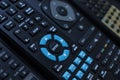 Many black remote tv control devices close up
