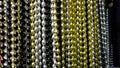 Many black, white, silver, gold and golden beads party neacklaces for New Years celebrations or background. Macro close Royalty Free Stock Photo