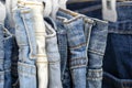 Many blue jeans on hangers for sale in street market in Thailand, close up Royalty Free Stock Photo