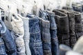 Many blue jeans on hangers for sale in street market in Thailand, close up Royalty Free Stock Photo