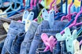 Many blue jeans on hangers for sale in street market in Thailand, close up Royalty Free Stock Photo