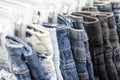 Many blue jeans on hangers for sale in street market in Thailand, close up Royalty Free Stock Photo