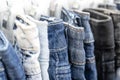 Many blue jeans on hangers for sale in street market in Thailand, close up Royalty Free Stock Photo