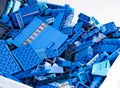 Many blue Lego blocks, bricks and pieces in a large plastic container
