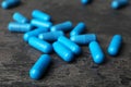 Many blue pills on dark surface Royalty Free Stock Photo
