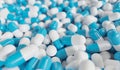 Many blue and white capsules on background. Drugs and pharmacy concept. 3D rendered illustration. Royalty Free Stock Photo