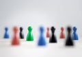 Many board game pawns on table, selective focus on the green one