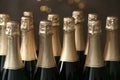 Many bottles of champagne on blurred background