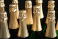 Many bottles of champagne on dark, closeup