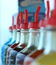 Many bottles of colored syrup for preparing ice creams