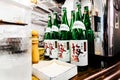 Many bottles of Japanese Sake on the counter in Japanese Izakaya restaurant