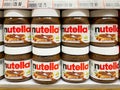 Many bottles of Nutella chocolate on shelf for sale in the Foodland supermarket