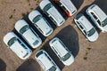 Many brand new cars covered in protective foil on sale parked outside on dealer parking lot Royalty Free Stock Photo