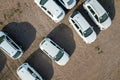 Many brand new cars covered in protective foil on sale parked outside on dealer parking lot Royalty Free Stock Photo