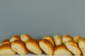 Many breads are placed in a tray with a gray background