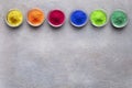 Many bright colors in bowls on gray background Royalty Free Stock Photo