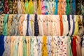 Many bright female scarfs and shawl. colorful scarves hanging in the market. clothes rack with a selection of scarves or scarfs. Royalty Free Stock Photo