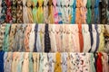 Many bright female scarfs and shawl. colorful scarves hanging in the market. clothes rack with a selection of scarves or scarfs. Royalty Free Stock Photo