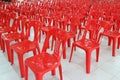 Many bright red plastic chairs arranged in a white floor in the meeting room Royalty Free Stock Photo