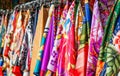 Many bright silk neckerchiefs on the store rack Royalty Free Stock Photo