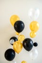 Many bright yellow white and black balloons isolated on backdrop. Royalty Free Stock Photo