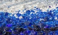 Many broken pieces of glass in white and blue as background