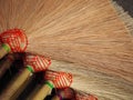 Many brooms on the floor for sale. It is a handmade product. From people in Thai countryside