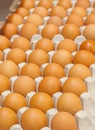 Many brown eggs in boxes in store close up