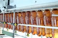 Many brown plastic bottles go on conveyor belt