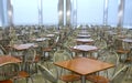 Many brown square eating tables and metal chairs staying in empty cafe hall Royalty Free Stock Photo