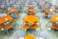 Many brown square eating tables and metal chairs staying in empty cafe hall Royalty Free Stock Photo