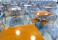 Many brown square eating tables and metal chairs staying in empty cafe hall Royalty Free Stock Photo