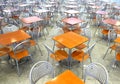 Many brown square eating tables and metal chairs staying in empty cafe hall Royalty Free Stock Photo