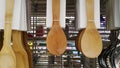 Many brown wooden ladle and spatula hanging for sale at kitchenware shop. Royalty Free Stock Photo