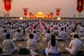 Many Buddhists doing meditation in front of Dhammakaya Cetiya