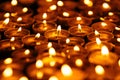 Many burning candles in dark. Yellow candles on black background Royalty Free Stock Photo