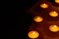 Many burning circle candles and ancient burnt paper sheets Royalty Free Stock Photo