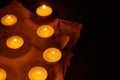 Many burning circle candles and ancient burnt paper sheets Royalty Free Stock Photo