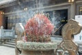 Many of burning incense sticks in joss stick burner pot with smoke in the Chinese temple Royalty Free Stock Photo